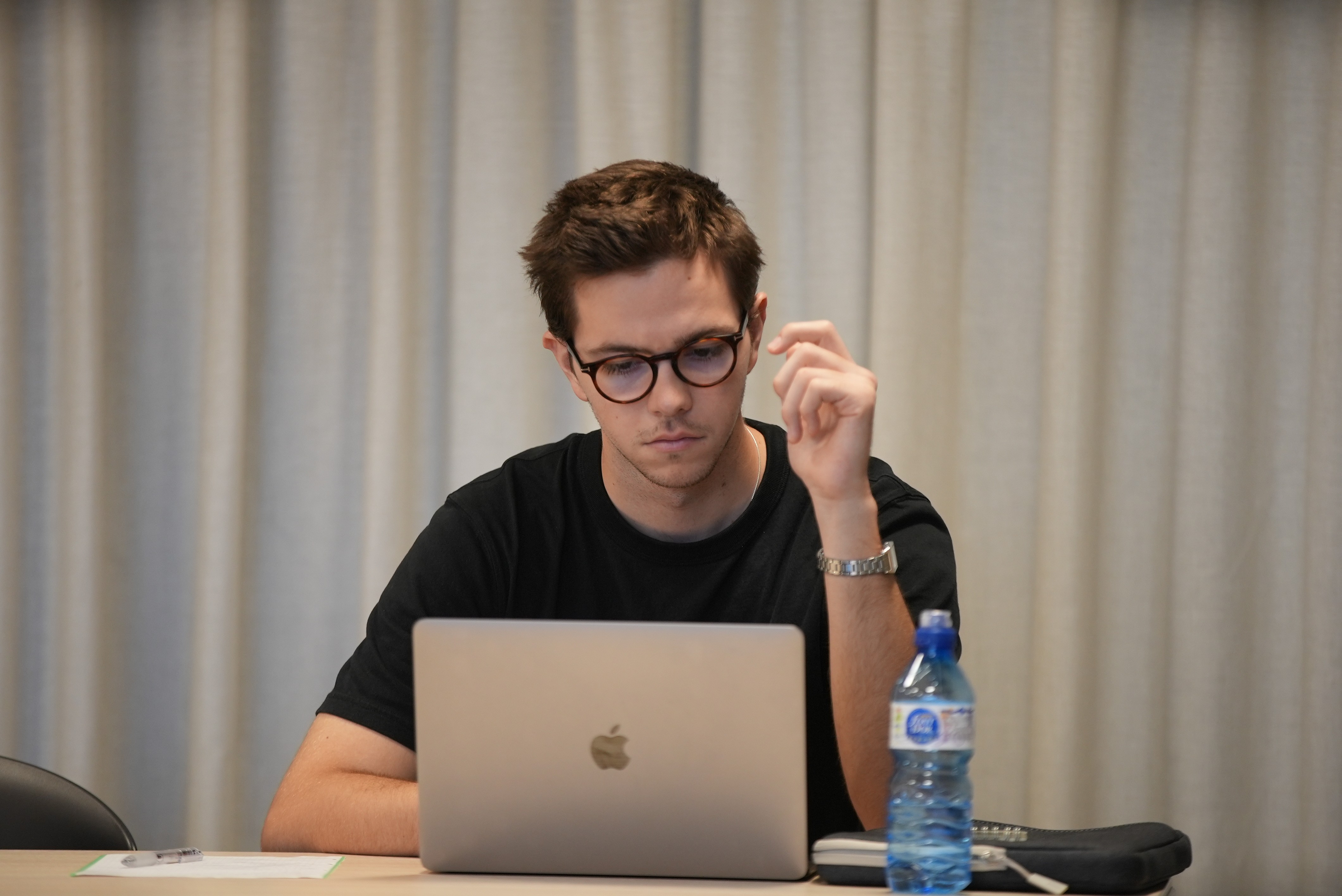 Student concentrating while working at a laptop during a prep class